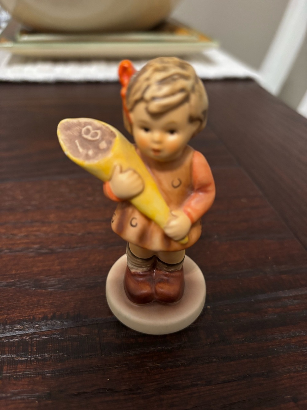 Hummel-Hand-Painted Ceramic Girl Figurine in Orange and Brown